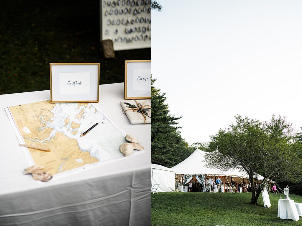 Guest book table with coastal map and tent reception set on a grassy lawn at Inn at Diamond Cove in Maine.