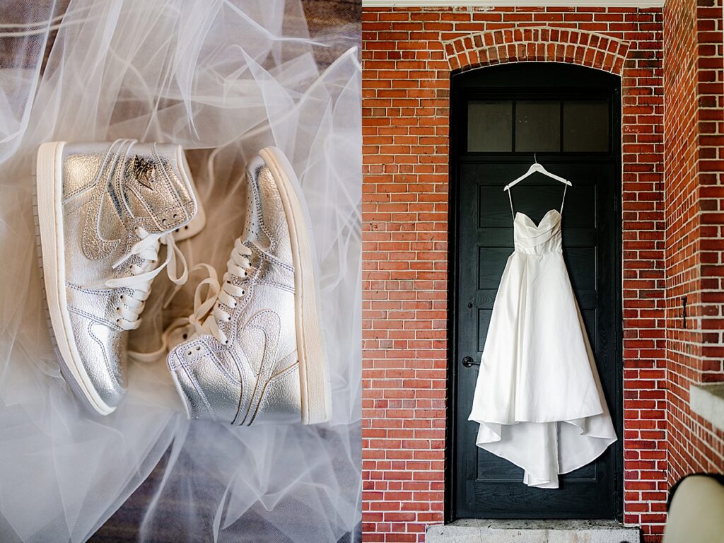 Silver sneakers on tulle beside a hanging wedding dress against a brick wall at Inn at Diamond Cove in Maine.