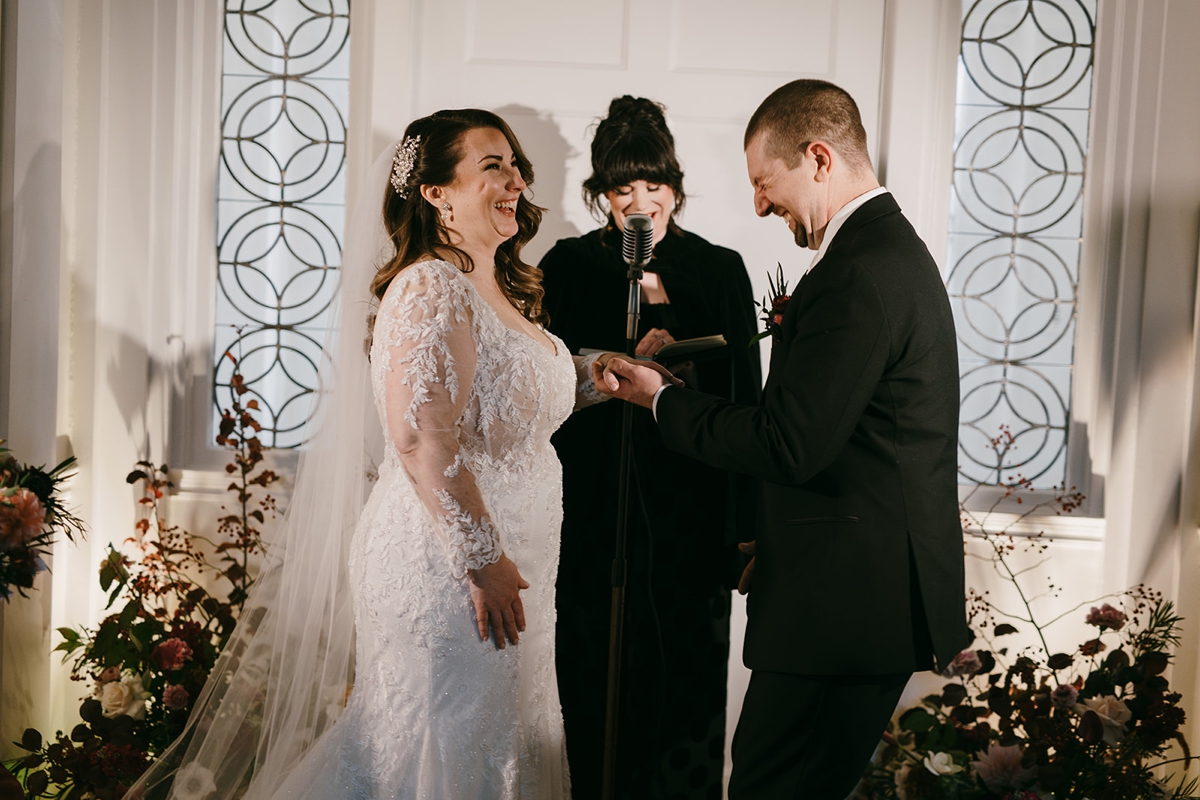 Couple exchanging rings during their intimate wedding ceremony in Portland, Maine.