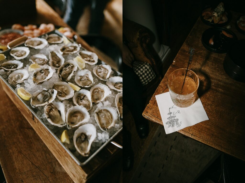 Left: Fresh oysters on ice with lemon wedges displayed on a wooden table at cocktail hour. Right: Old fashioned cocktail on a napkin with custom wedding monogram on a wooden bar.
