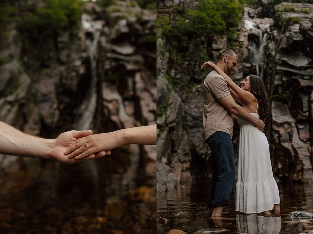 Close-up of couple holding hands in a mountain stream and the couple embracing barefoot beneath a rocky waterfall during a New Hampshire engagement session.