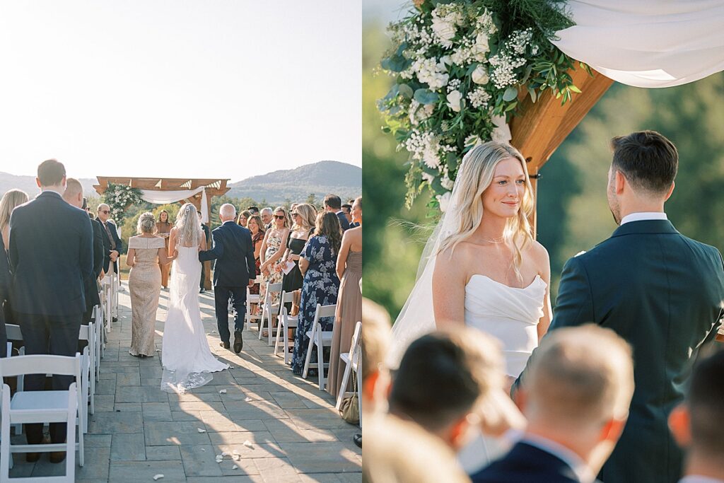 Bride walking down the aisle with family and smiling at the groom during an outdoor mountain ceremony.