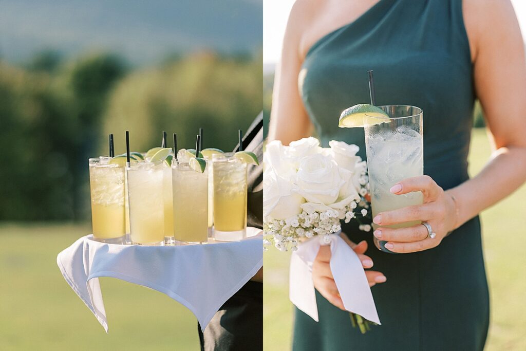 Cocktail hour drinks with lime garnishes served on a tray and a guest holding a drink beside a white bouquet.