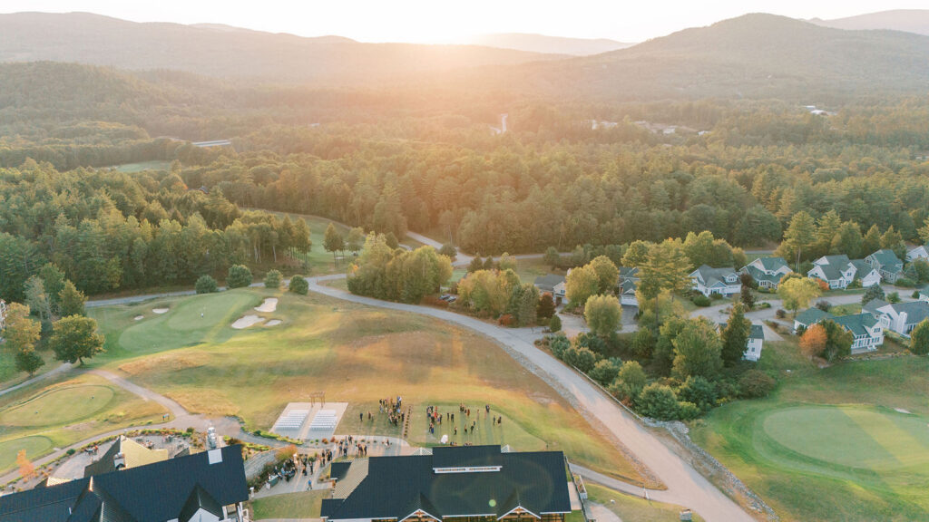 Golden hour aerial view of the ceremony setup and surrounding mountains at Owl’s Nest Resort.
