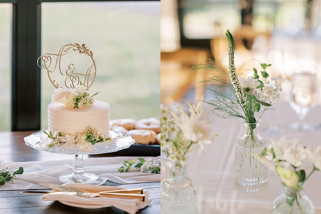 Small wedding cake with monogram topper beside delicate floral centerpieces on a reception table.