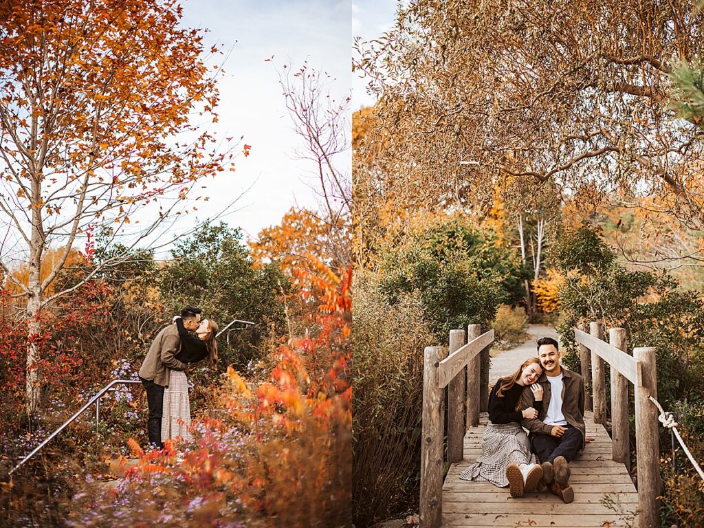 Couple kissing among vibrant autumn foliage and wildflowers near garden path during fall engagement session.